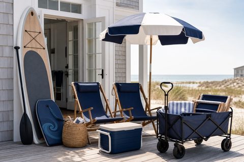 Beach chairs, shade, cooler, wagon, and paddle board arranged for rental selection