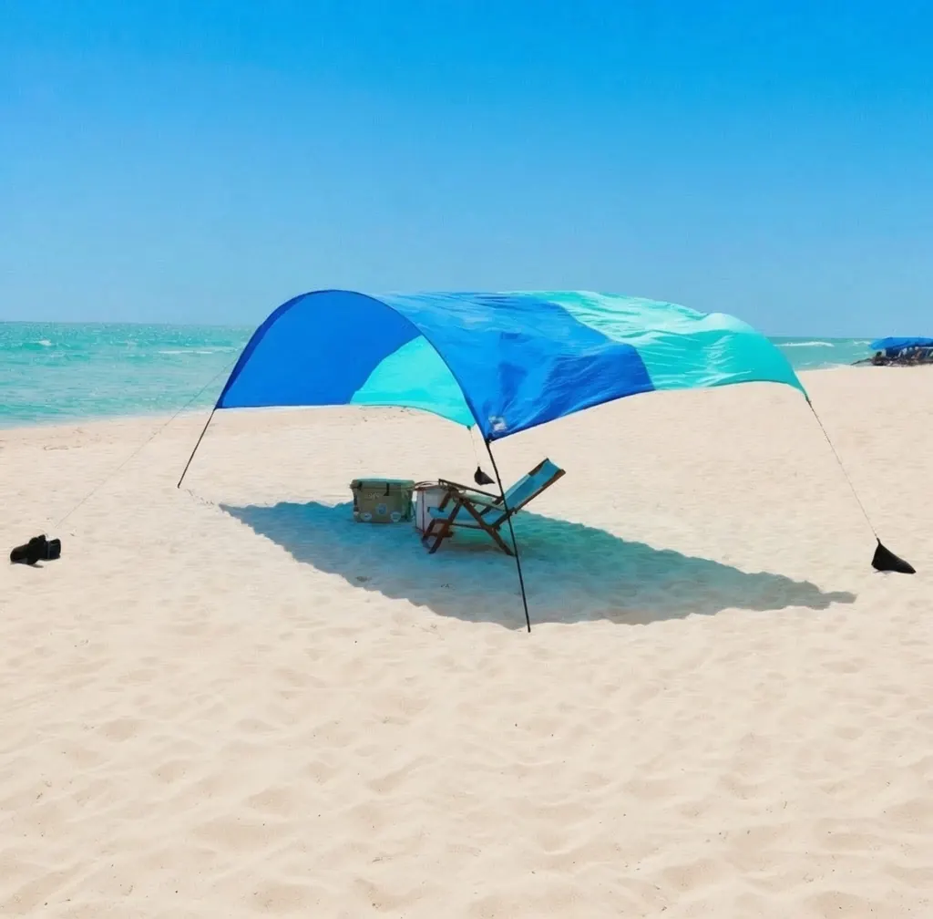 Blue Shibumi Shade set up on a wide sandy beach
